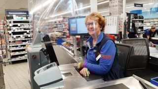 Deen caissière achter plastic