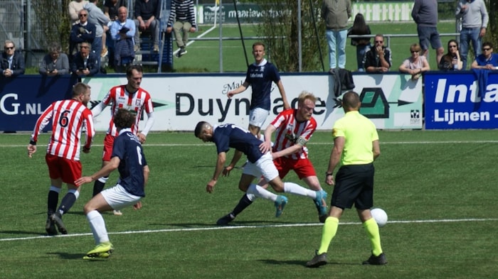 Quick - Hollandia - Bert Spil gaat voor in de verdedigende strijd. Milan Vissie en scheidsrechter John Jensch kijken toe.