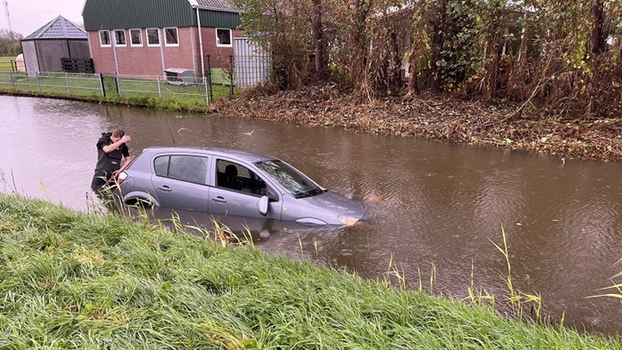 Auto te water langs de Venneweg in Berkhout